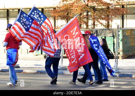 Washington DC. Nov 14, 2020. Million Maga March. Rear side view of people carrying 2nd Amendment flag, Maga country flag and Trump flag. Stock Photo