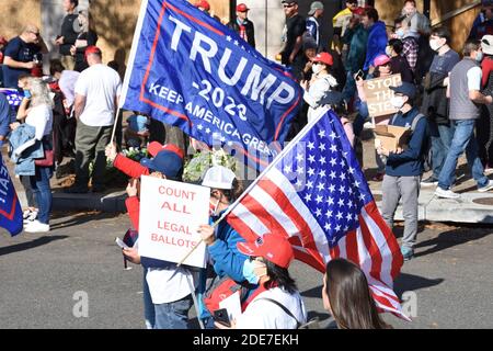 Washington DC. Nov 14, 2020. Million Maga March. People with mask holding American flag and Trump 2020 flag with “count all legal ballots” placard Stock Photo