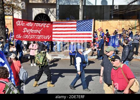 Washington DC. Nov 14,2020. Million Maga March. People walking with big banner “We the people defend the Constitution- American flag” at Freedom Plaza