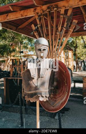 Exhibition of Medieval knightly armor in ancient fortress. Swords, shields and other weapons. Stock Photo