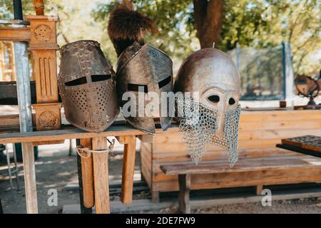 Exhibition of Medieval knightly armor in ancient fortress. Swords, shields and other weapons. Stock Photo