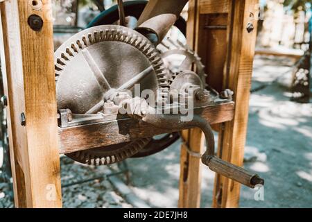 Well lifting mechanism close-up. Gate raising gear at medieval fortress. Rusty wheel and cog of manual antique machinery. Stock Photo