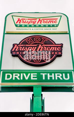A Krispy Kreme Doughnuts sign stands outside a store, Nov. 28, 2020, in Ocean Springs, Mississippi. Krispy Kreme is an American doughnuts chain. Stock Photo