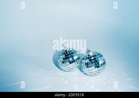 Two disco balls on blue background with reflections, copyspace Stock Photo