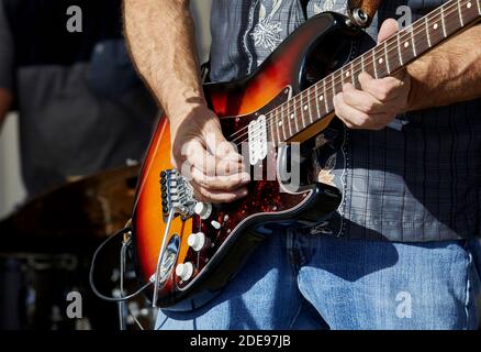Close up of the hands of a musician playing an electric guitar Stock Photo
