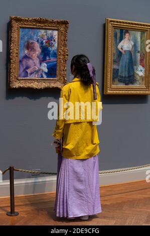 museum visitor admiring painting at the Art Institute in Chicago Stock Photo