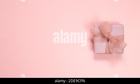 Pink gift box isolated on pink background. top view, copy space Stock Photo