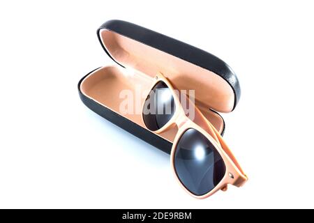 pink sunglasses in black opened case on white background Stock Photo