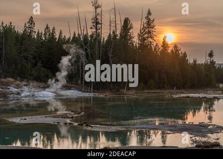 Crackling Spring is a hot spring on the edge of Crackling Lake in the Porcelain Basin in the Norris Geyser Basin in Yellowstone National Park, Wyoming Stock Photo