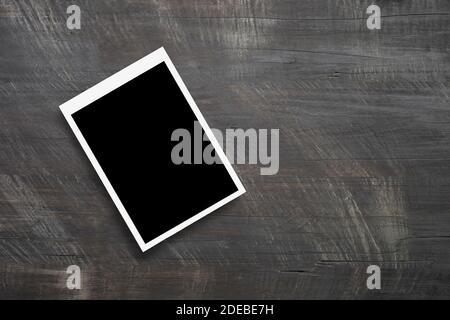 Top view of blank photo frames on wooden table background. Stock Photo