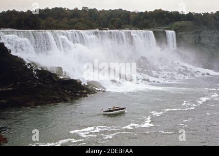 1970s Photo (1973) -  The American Niagara Falls seen from the Canadian side of the Niagara River. A Maid-of-the-Mist sightseeing boat is in foreground Stock Photo