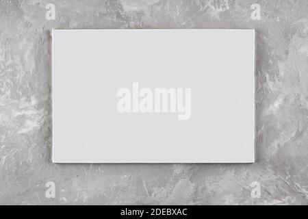 White sheet on a gray abstract background under the concrete. Space for text. Stock Photo