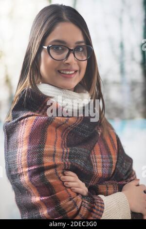 Portrait of a woman smiling wrapped in a shawl Stock Photo