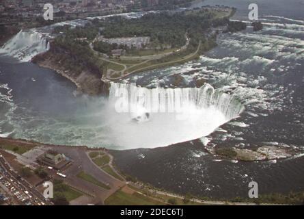 '1970s Photo (1973) -  Aerial view of Niagara Falls showing the American falls (upper left) and the Canadian or ''Horseshoe Falls'' (center)' Stock Photo