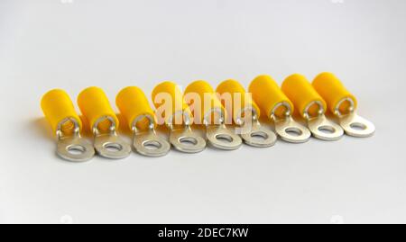 electrical crimp terminal isolated on white background. metal connector. tips for cables and wires. reliable electrical contact.  Stock Photo
