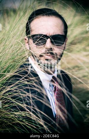 Man in suit wearing sunglasses Stock Photo