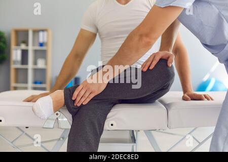 Close up of male athlete receiving professional help in medical center after sports injury. Stock Photo