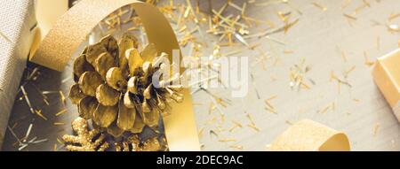 A thin curly gold ribbon for Christmas and birthday present banner isolated  against a white background Stock Photo - Alamy