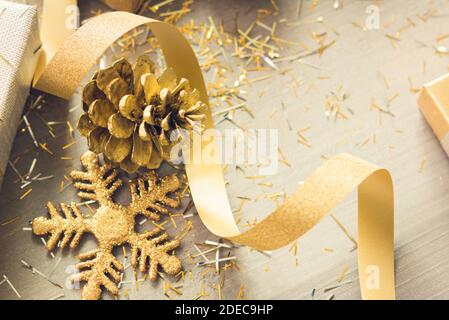 A thin curly gold ribbon for Christmas and birthday present banner isolated  against a white background Stock Photo - Alamy