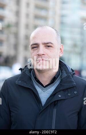 Man looking at camera smiling outdoors Stock Photo