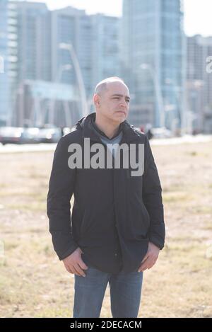 Pensive 45 years old man looking away outdoors Stock Photo