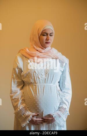 Pregnant Muslim woman in pain Stock Photo
