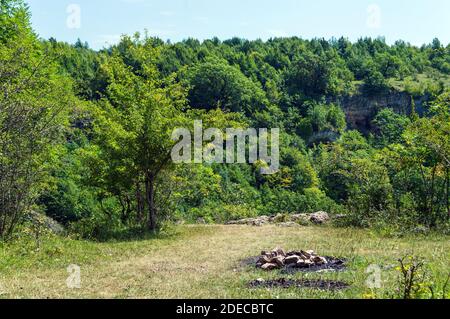 Camp fire after burning in mountain forest in Adygeya respublic in South of Russia Stock Photo