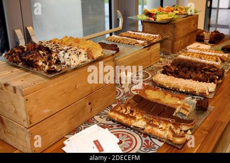 Dinner buffet table laid out with an assortment of food at an evening event Stock Photo