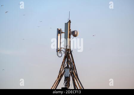 Technology of telecommunication GSM 5G,4G,3G tower. Cellular phone antennas. Receiving and transmitting stations Stock Photo