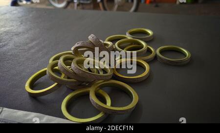 Silencer or muffler gaskit isolated on a gray background. Two wheeler spare parts. Stock Photo