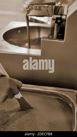 Mixing and blending Dark chocolate by an artisanal chocolatier Stock Photo