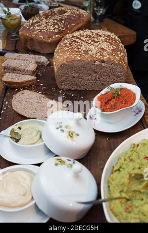 An assortment of freshly baked rolls and loaves of bread on a brunch buffet table Stock Photo