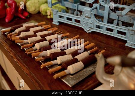 Chocolate flavoured ice cream on a cinnamon stick on a buffet table Stock Photo
