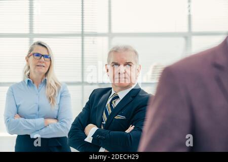 close up. thoughtful serious employees standing in the office Stock Photo