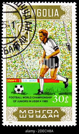 MOSCOW, RUSSIA - OCTOBER 17, 2020: Postage stamp printed in Mongolia shows Soccer players, Junior World Soccer Championships, Moscow serie, circa 1985 Stock Photo