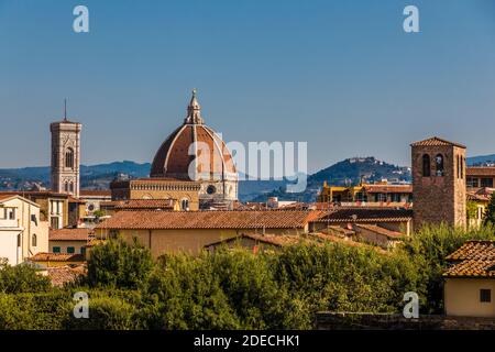 Beautiful panoramic rooftop view from Boboli Gardens of Florence with the Giotto's bell tower and the Duomo. In the background are the typical Tuscan... Stock Photo