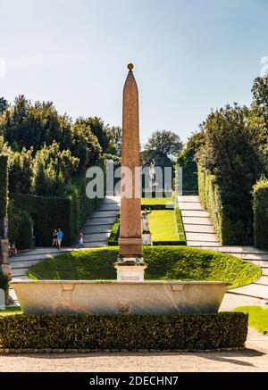 Lovely view of the ancient Egyptian red granite Boboli obelisk and the basin from the Palazzo Pitti towards the Boboli Gardens. In the background on... Stock Photo