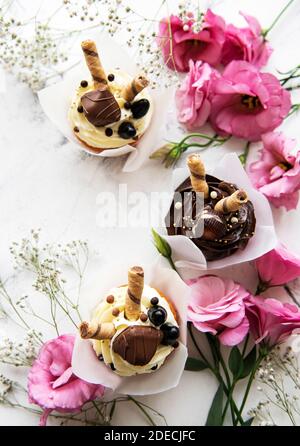 Chocolate cupcakes  for Valentine day on white marble background Stock Photo