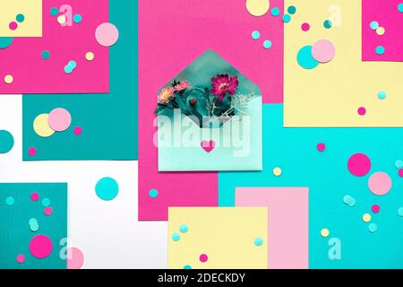 International Thank you day. Greeting card with circle round particles and flowers in small envelope. Concept geometric creative flat lay on layered Stock Photo
