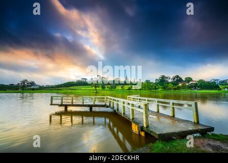 Dawn on love bridge overlooking the lake with the dramatic sky welcomes new day in the tourist city of Vietnam Stock Photo
