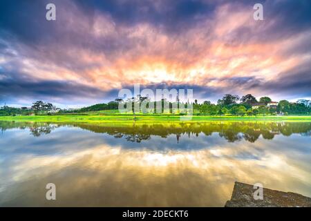 Dawn on love bridge overlooking the lake with the dramatic sky welcomes new day in the tourist city of Vietnam Stock Photo
