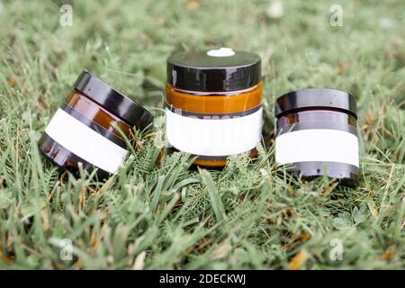 Bottles with empty stickers to copy paste lying on the green grass Stock Photo