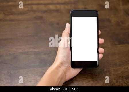 Woman hand presenting smartphone with empty white screen for montage your texts or pictures Stock Photo