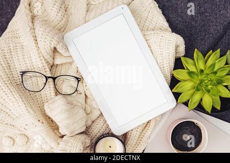 Tablet mock-up in lifestyle composition. Sweater, coffee, candle and glasses Stock Photo