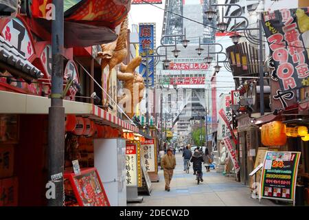 OSAKA, JAPAN - NOVEMBER 23, 2016: People visit Shinsekai neighborhood in Minami area of Osaka, Japan. Osaka belongs to 2nd largest metropolitan area o Stock Photo