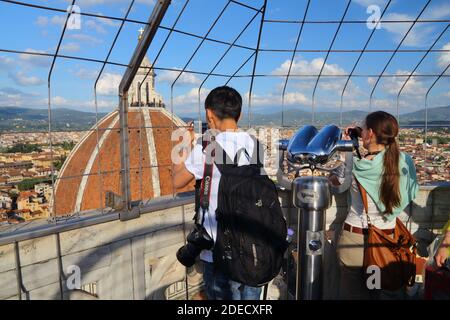 FLORENCE, ITALY - APRIL 30, 2015: People visit the viewpoint of Giotto's Campanile in Florence, Italy, a UNESCO World Heritage Site. Stock Photo