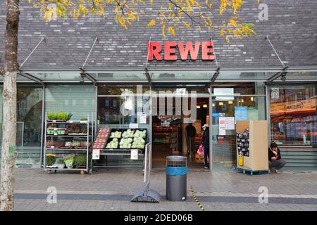 GELSENKIRCHEN, GERMANY - SEPTEMBER 17, 2020: People shop in Rewe supermarket in Gelsenkirchen, Germany. Rewe is a German supermarket chain.