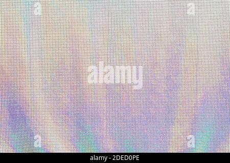 Rainbow textile fabric shining in neon colors. Iridescent texture background Stock Photo