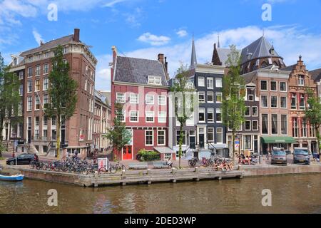 AMSTERDAM, NETHERLANDS - JULY 10, 2017: People visit Herengracht canal in Amsterdam, Netherlands. Amsterdam is the capital city of The Netherlands. Stock Photo