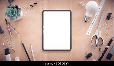 Responsive web design development. Work table with tablet and other office items. Stock Photo